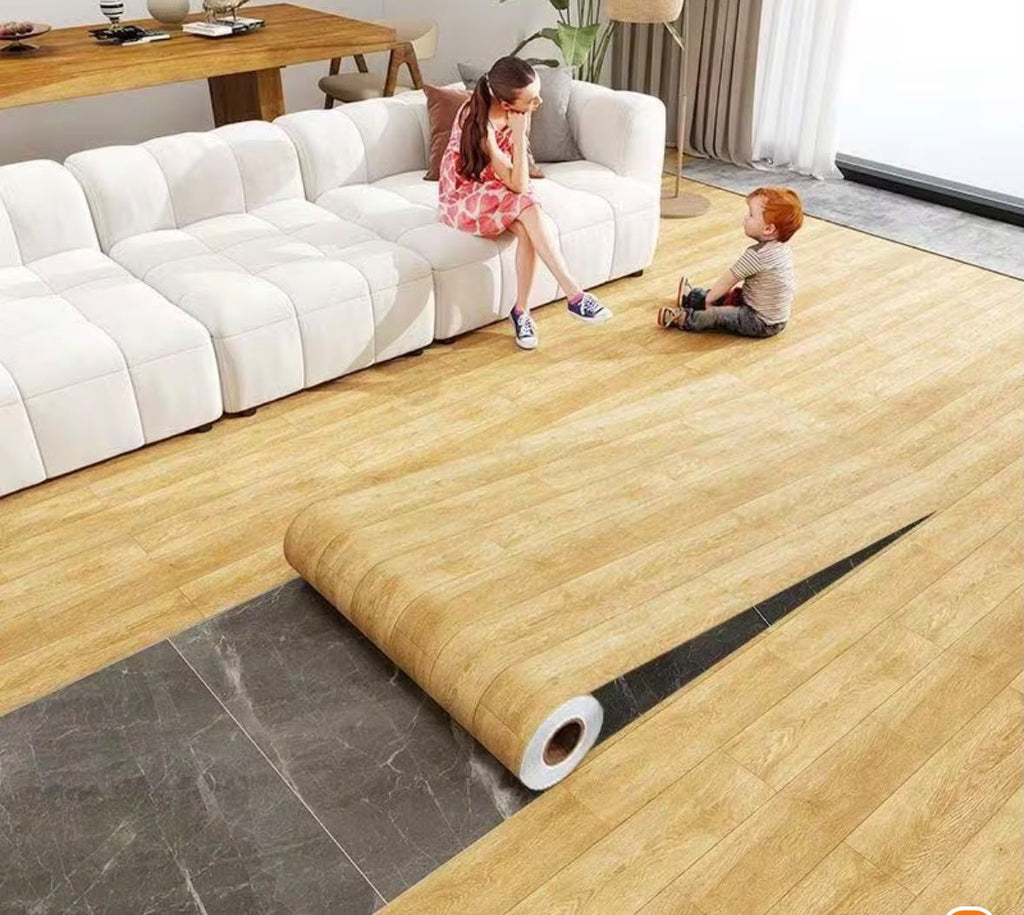 Self-adhesive wood grain decorative floor film being applied to a modern living room floor.