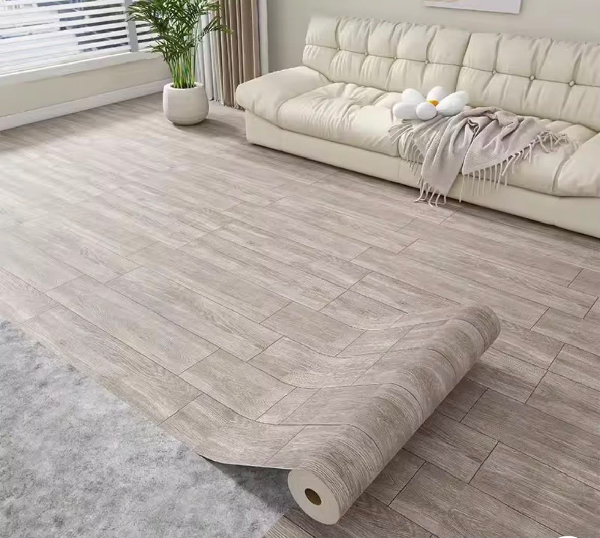Self-adhesive wood grain decorative floor covering roll in a modern living room.